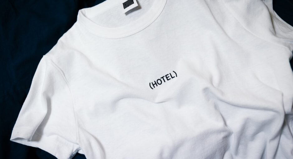 white hotel-printed crew-neck shirt on black surface